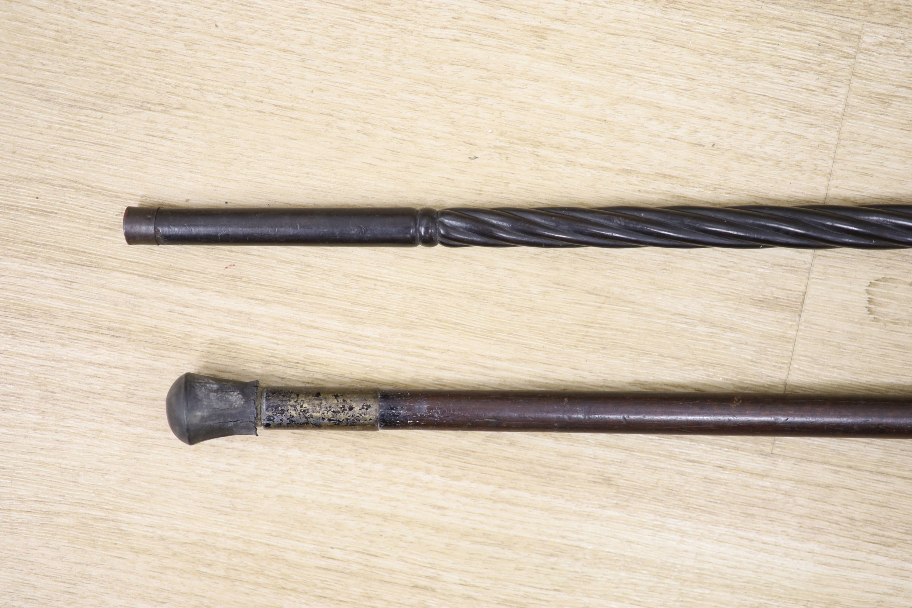 A 19th century Ceylonese ebony and silver topped walking stick and a white metal handled walking stick